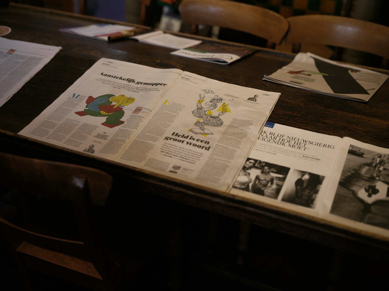 Newspapers and magazines on a wooden table
