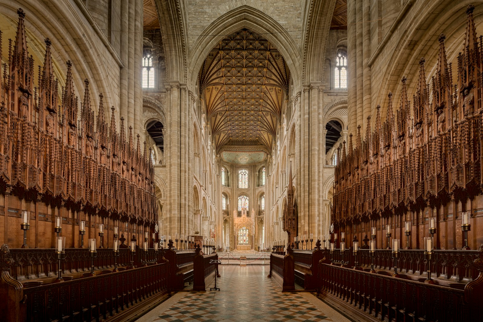 Grand gothic cathedral interior with long rows of choir stalls