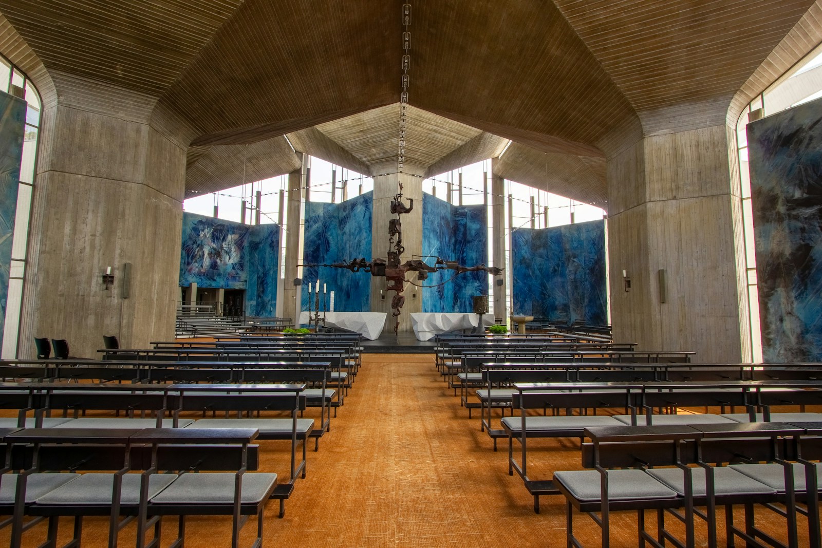 Modern church interior with concrete walls and blue art