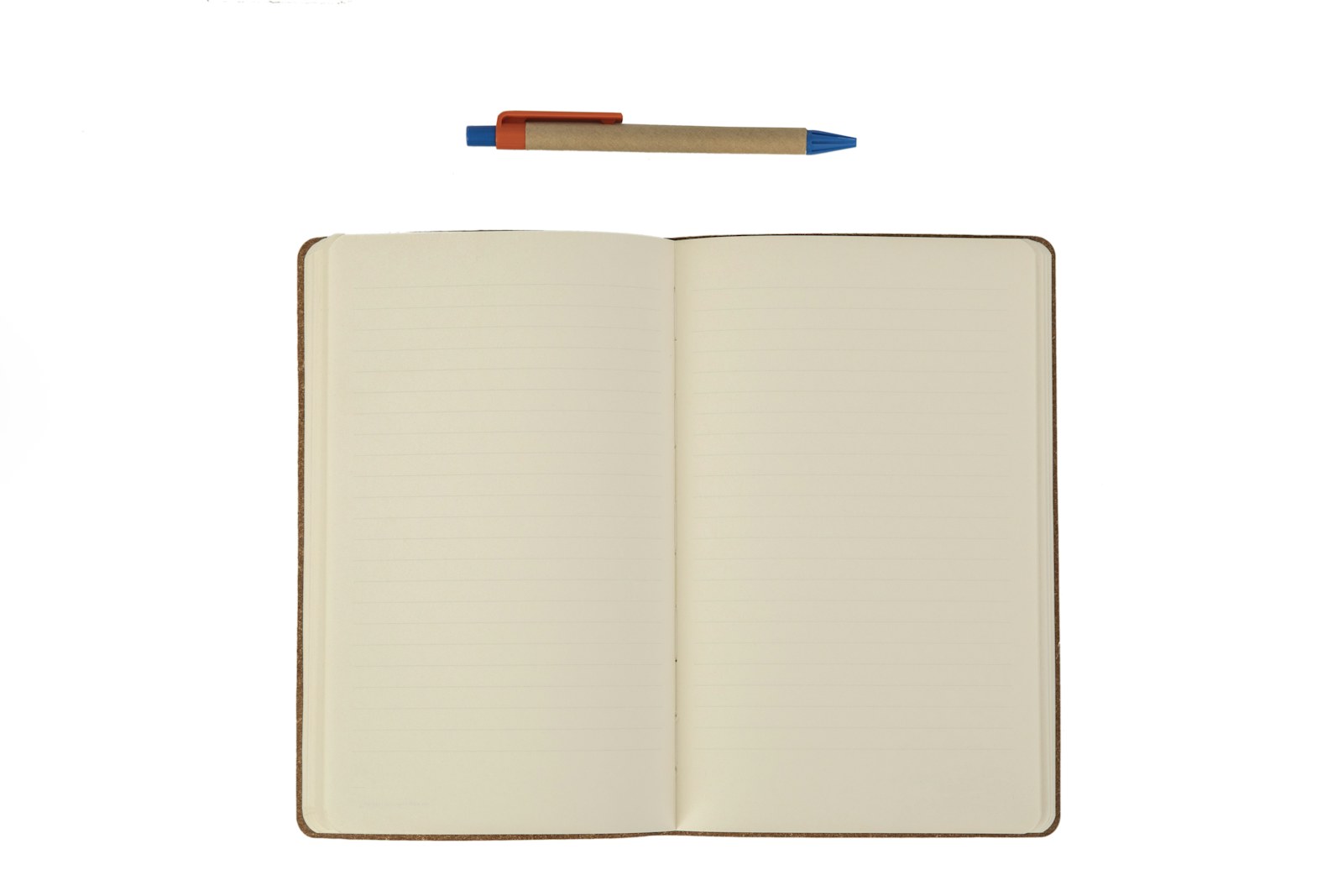 An open notebook with lined pages and a ballpoint pen above it
