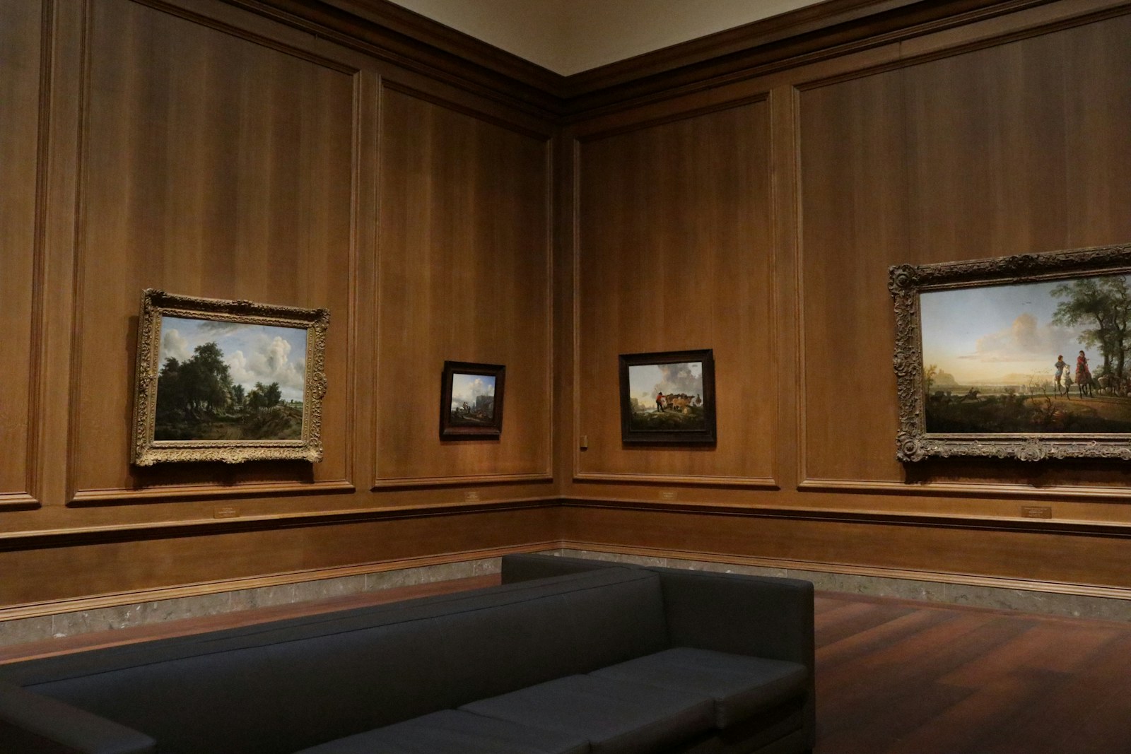 a couch in a room with paintings on the wall