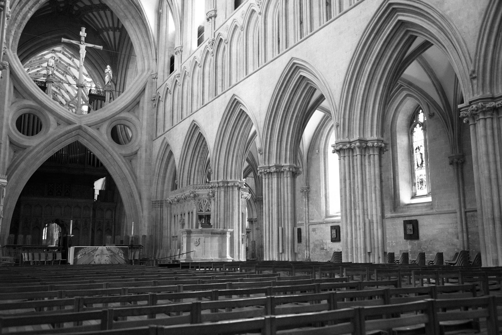 A black and white photo of a church with pews