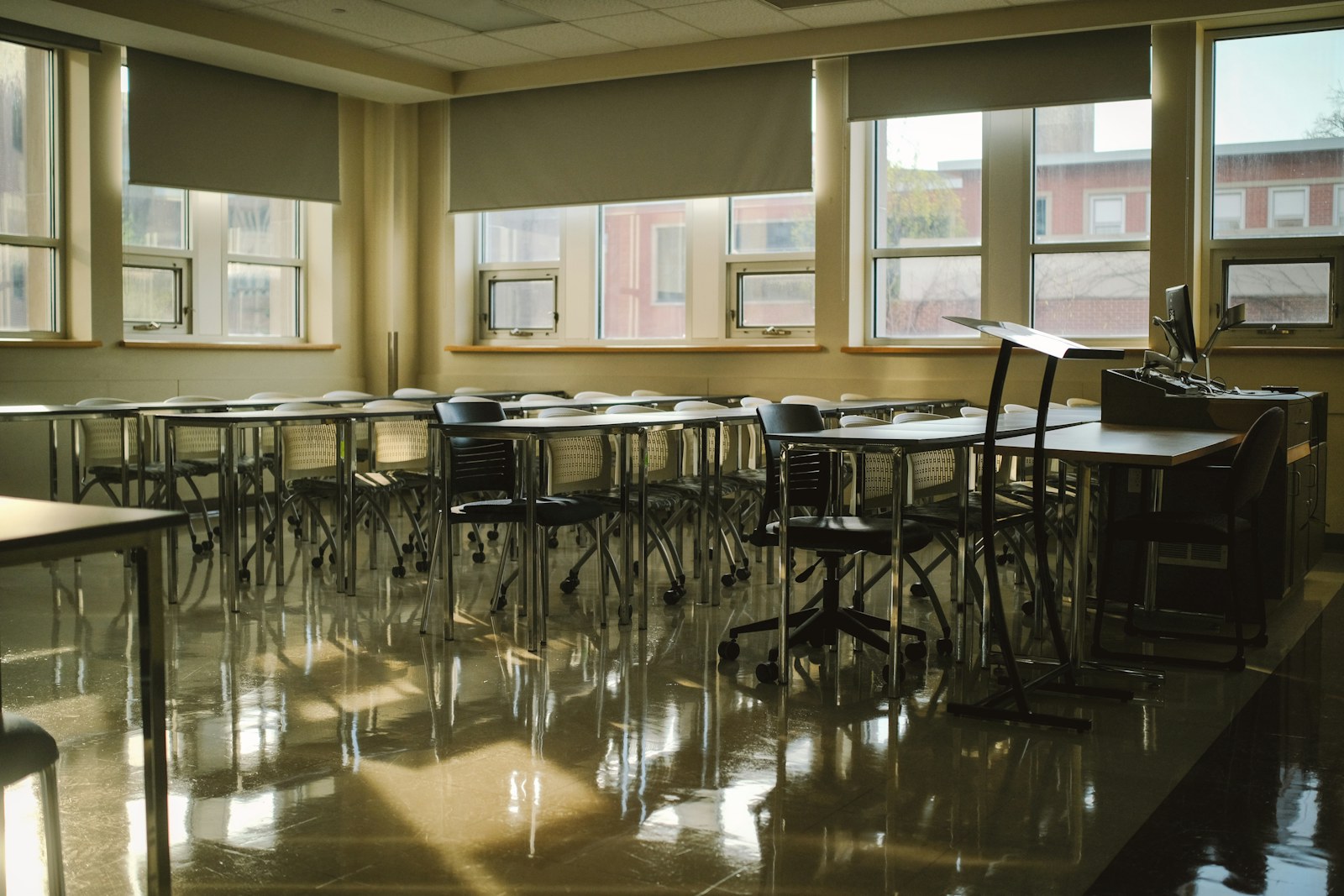A classroom is empty, with sunlight reflecting