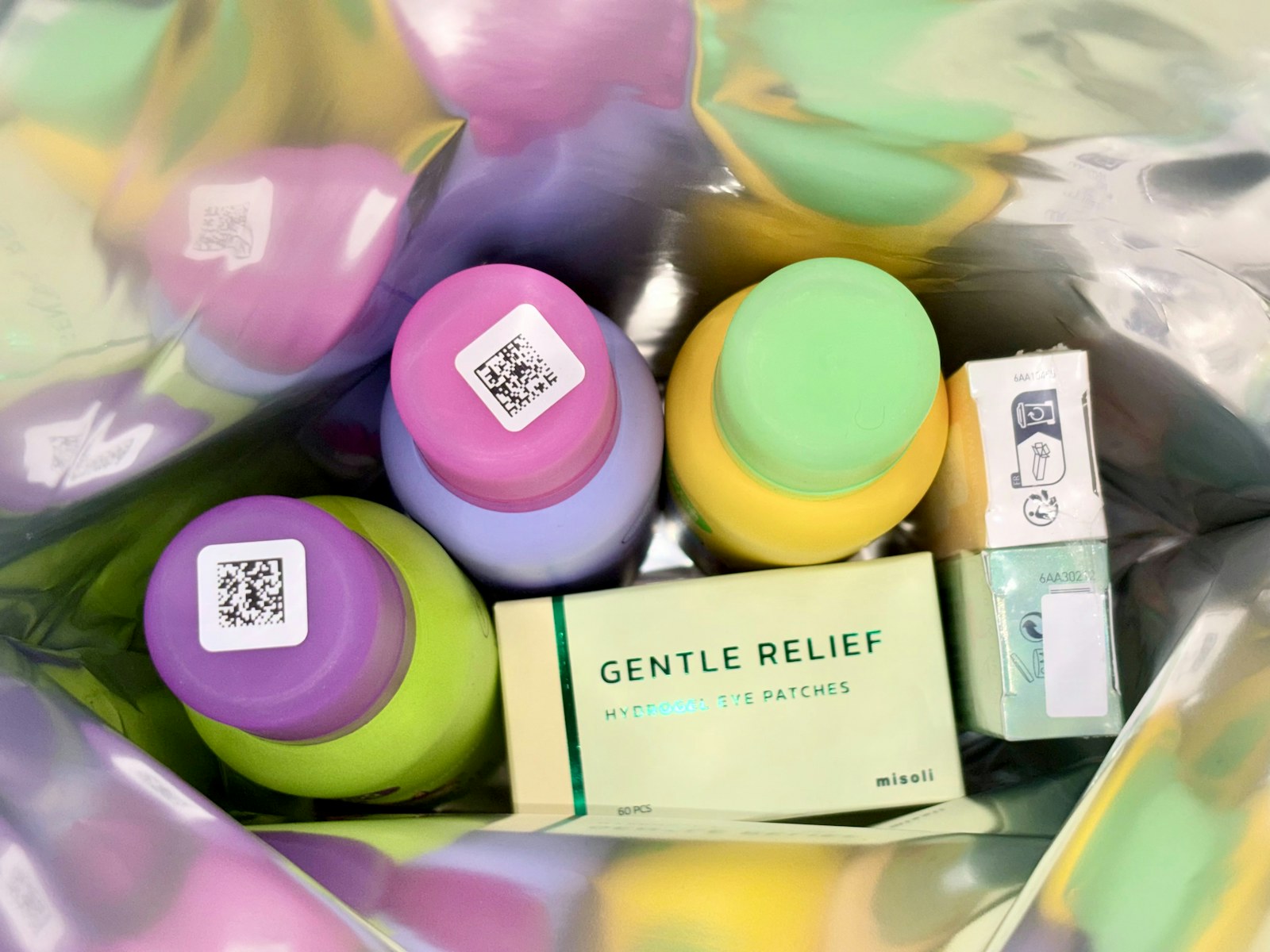 Colorful bottles and a box of patches inside a bag