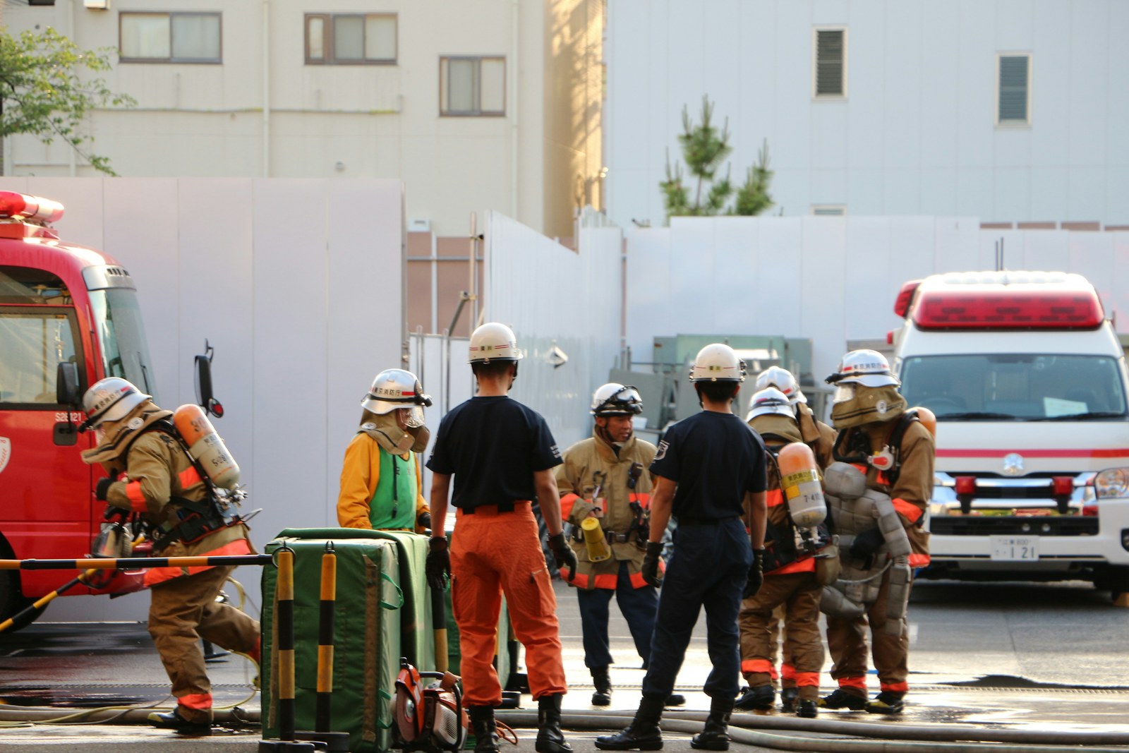 Firefighters and emergency personnel with a fire truck and ambulance