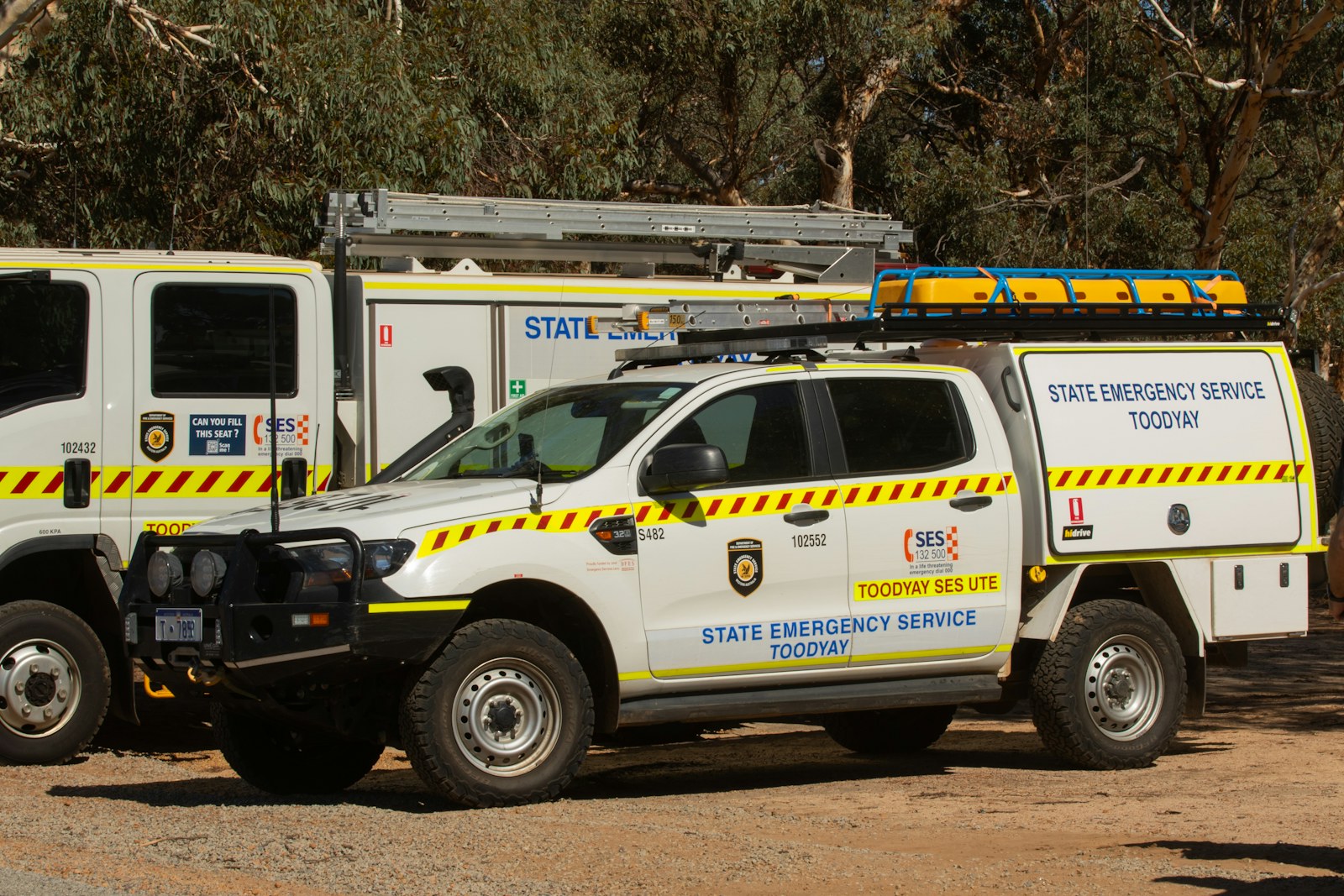 White state emergency service vehicles parked outdoors
