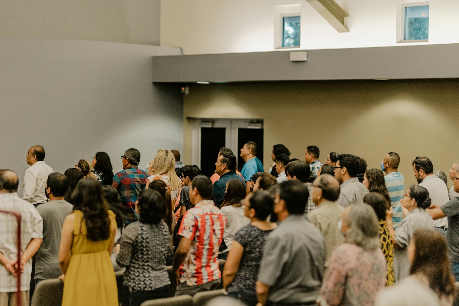 a large group of people standing in a room