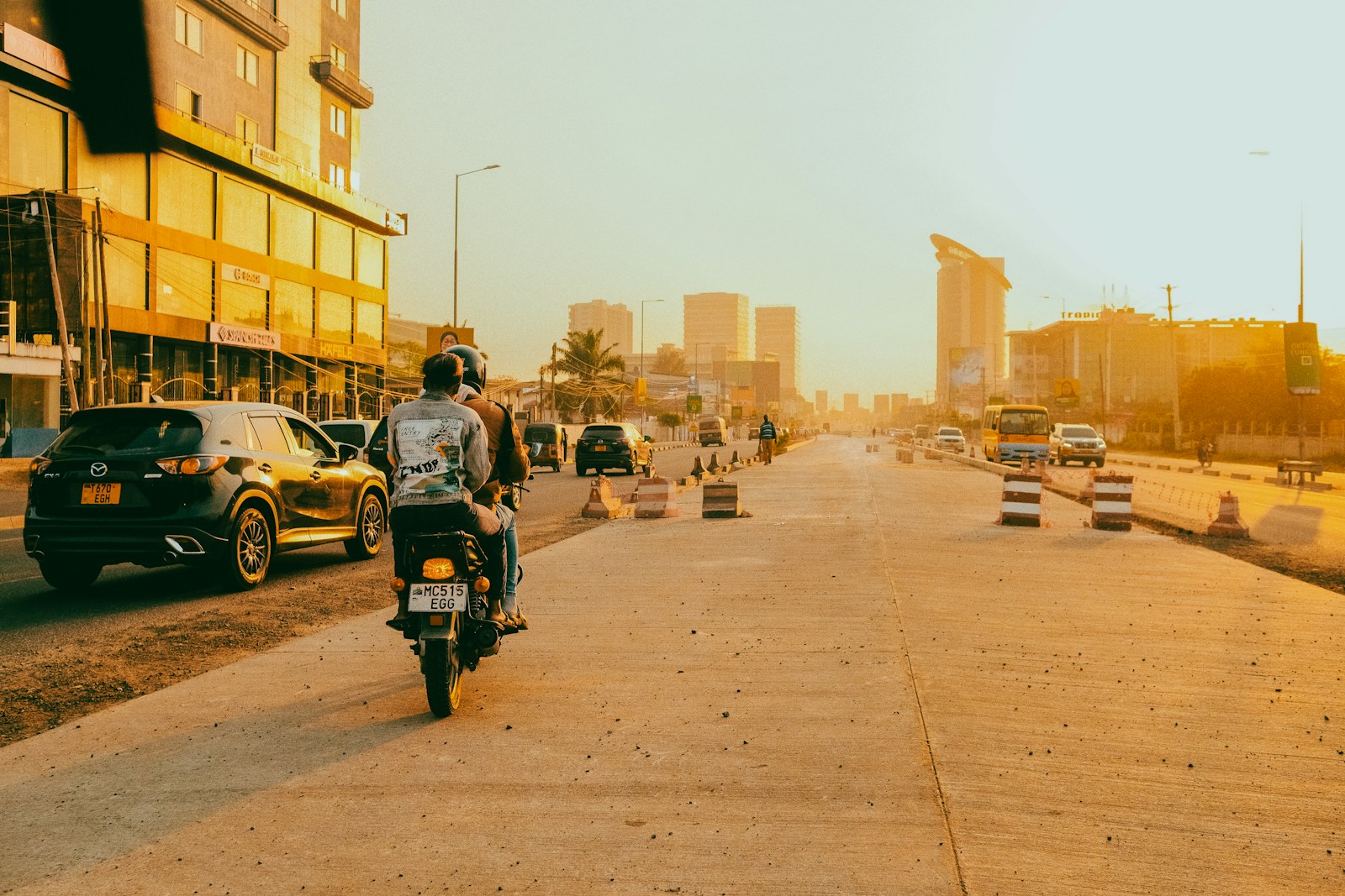 Motorcycle and cars on a sunny city street