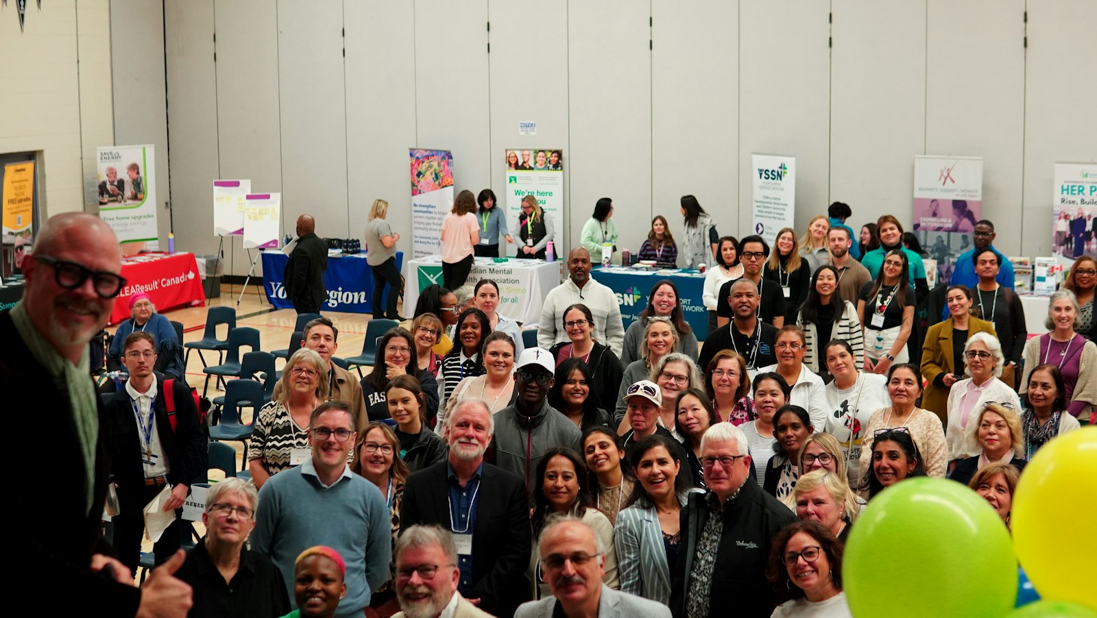 A large group of people gathered indoors at an event