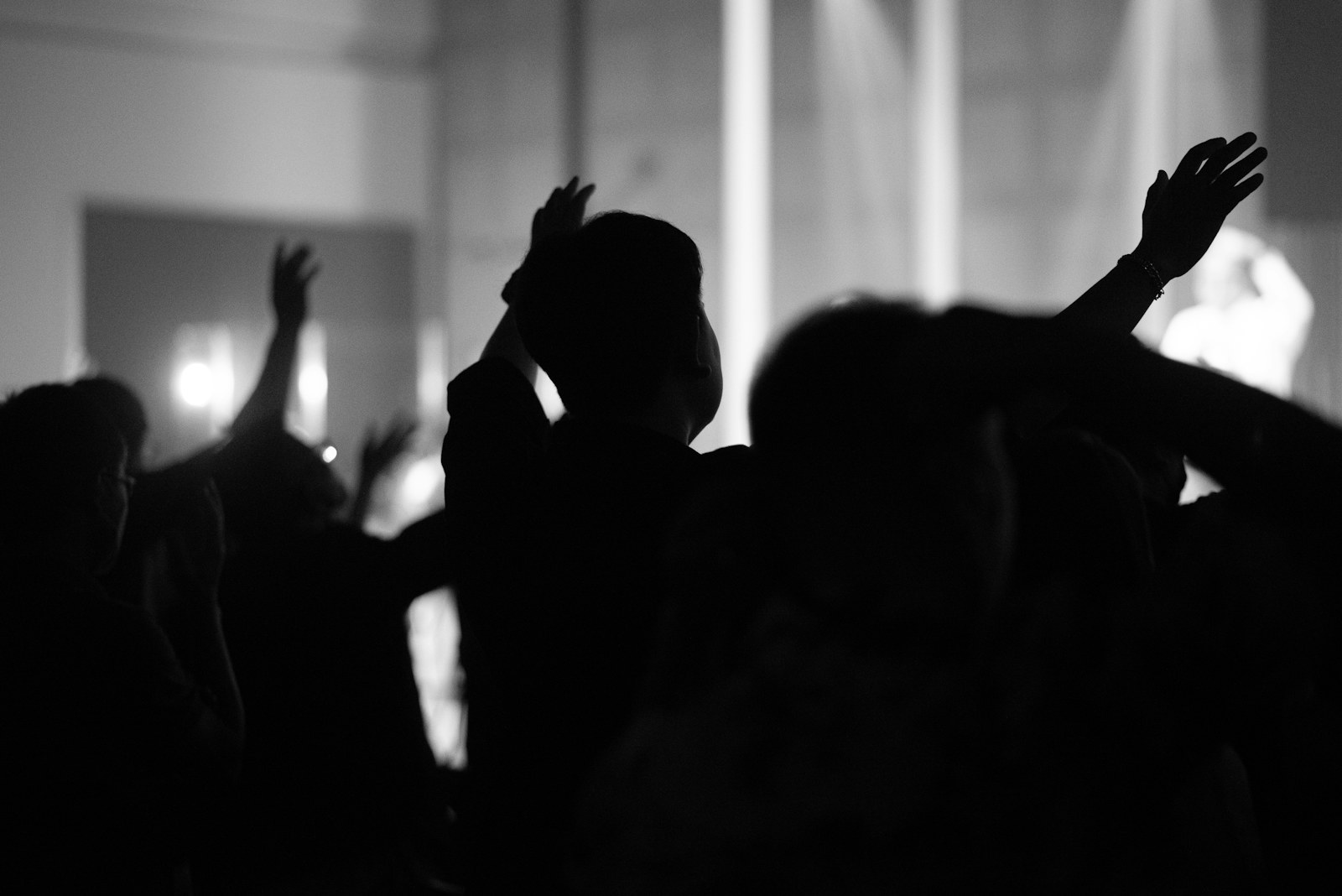 a group of people raising their hands in the air