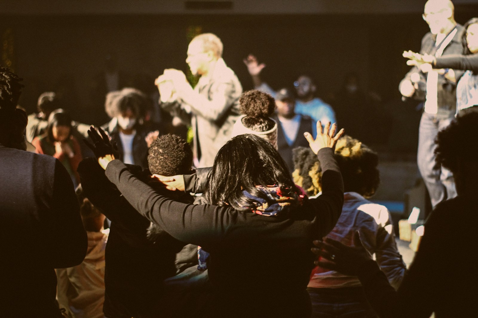 a group of people standing around each other