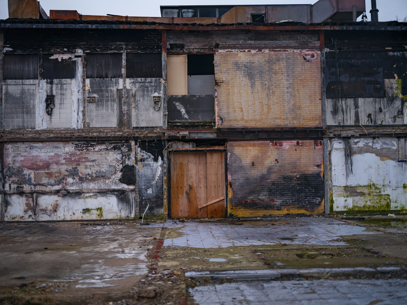 An old run down building with boarded up doors