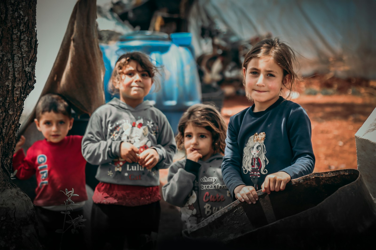 A group of children standing next to each other