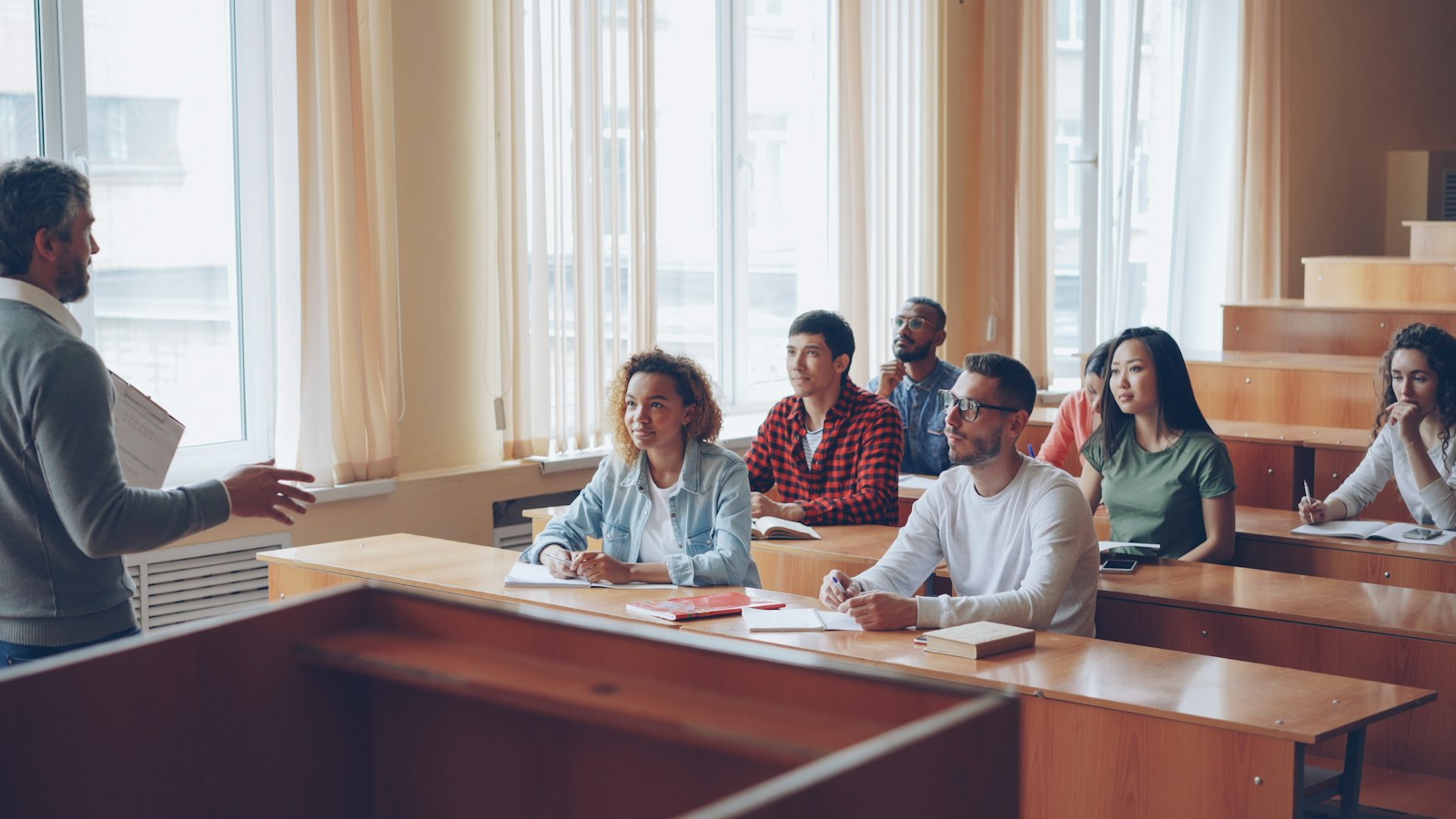 Professor lectures to students in a classroom setting