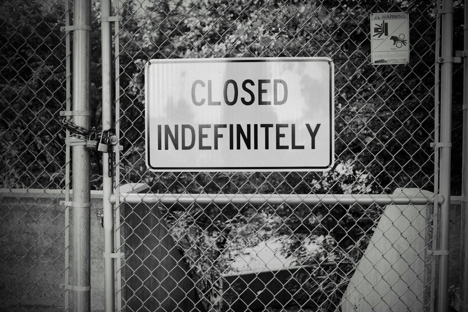 a close up of a sign on a chain link fence