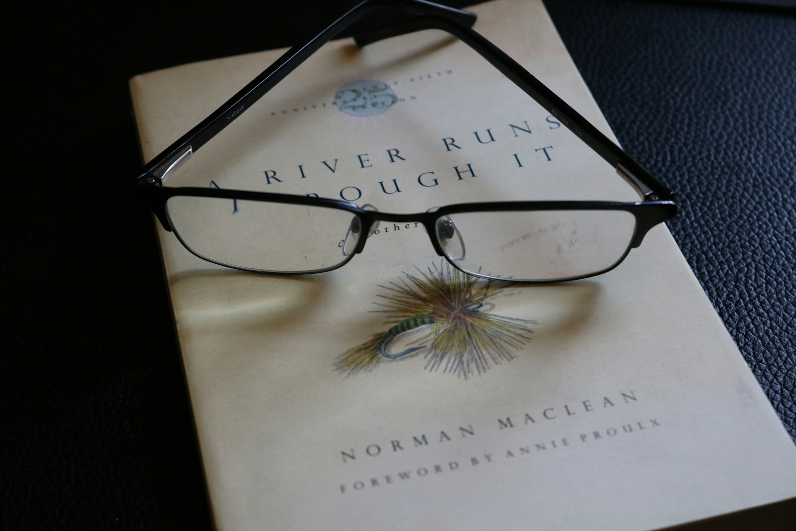 a book with a pair of glasses on top of it