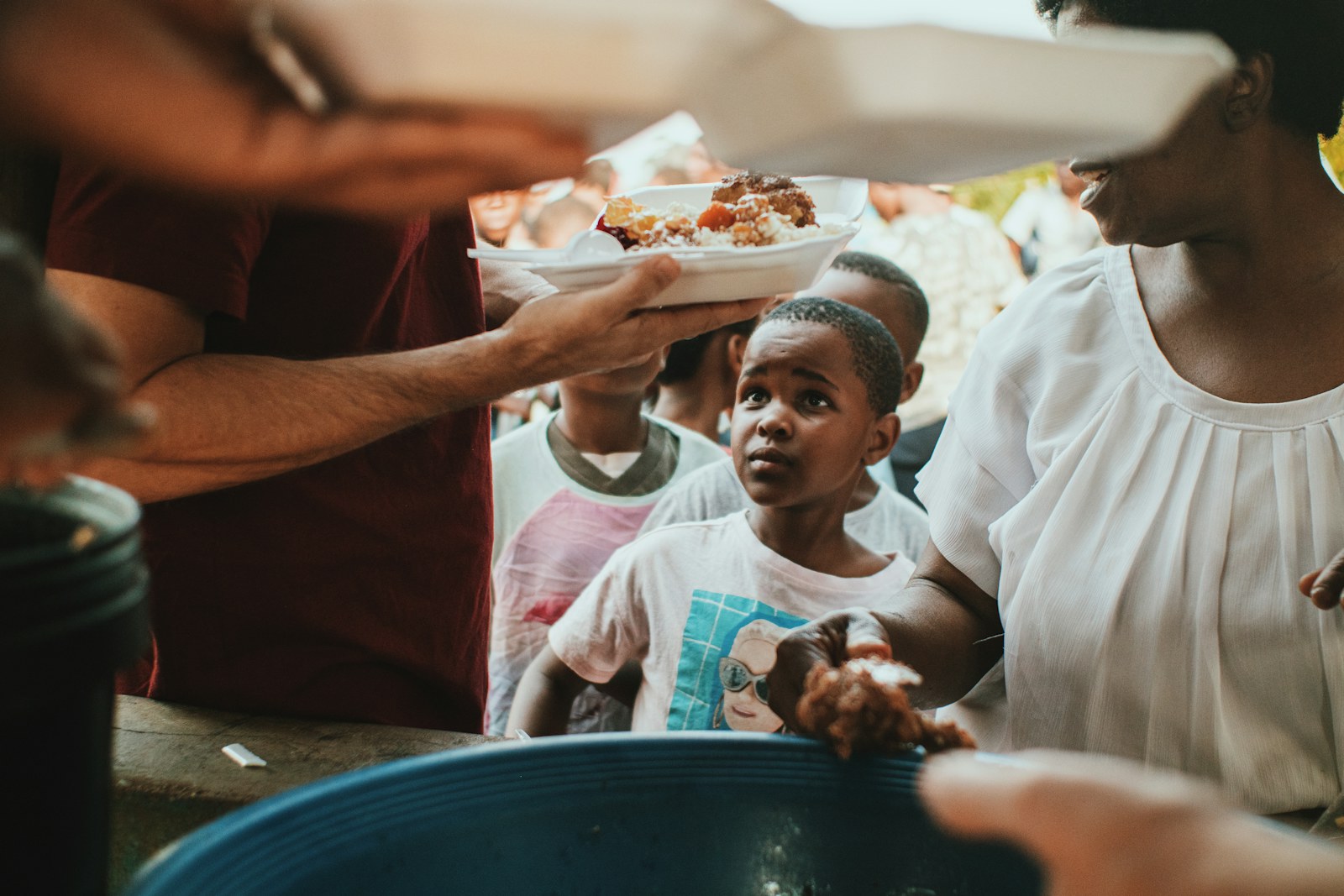 a group of people holding plates of food