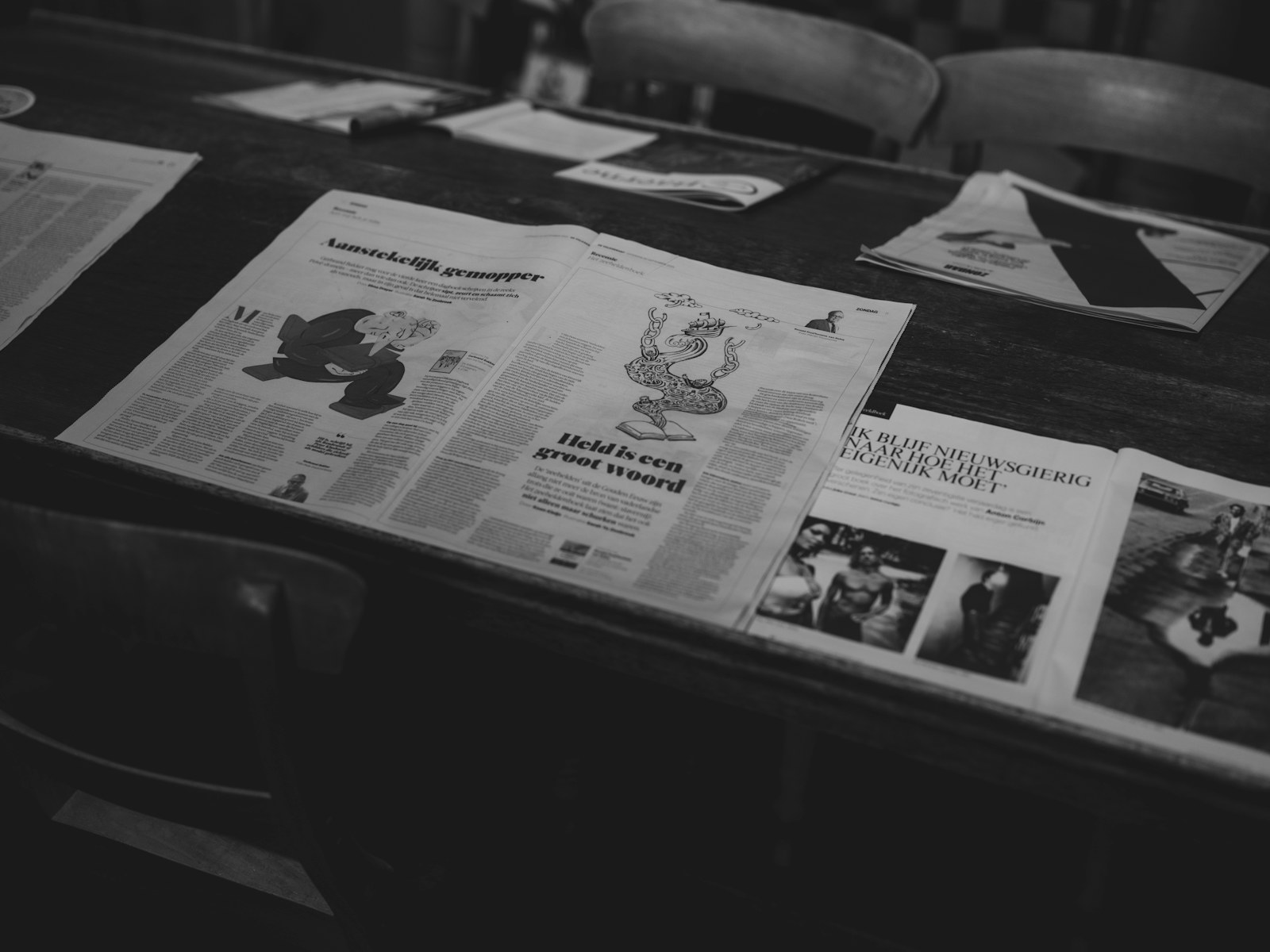 Newspapers laid out on a wooden table