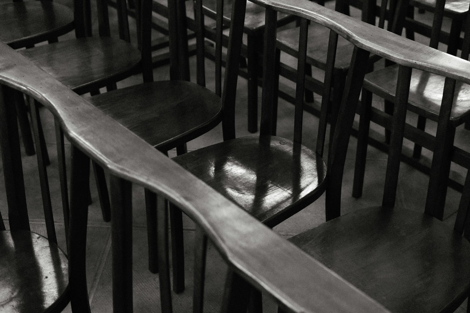 Rows of empty wooden chairs in a room