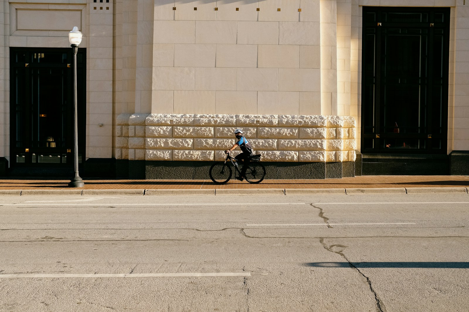 man in black jacket riding bicycle on gray concrete road during daytime