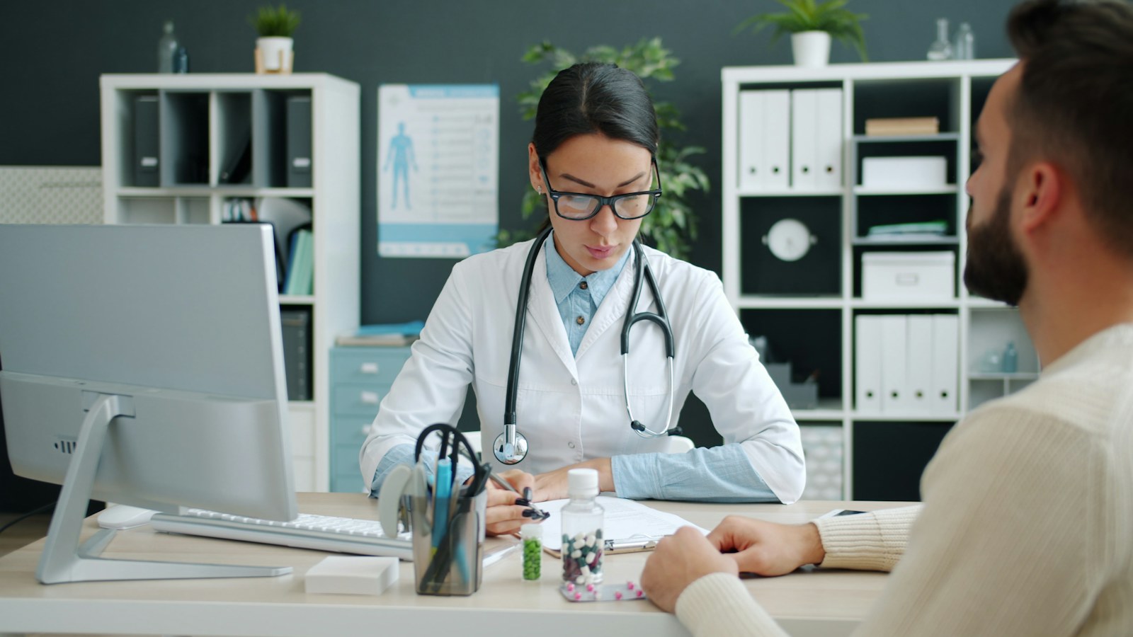 Doctor consulting with patient at desk