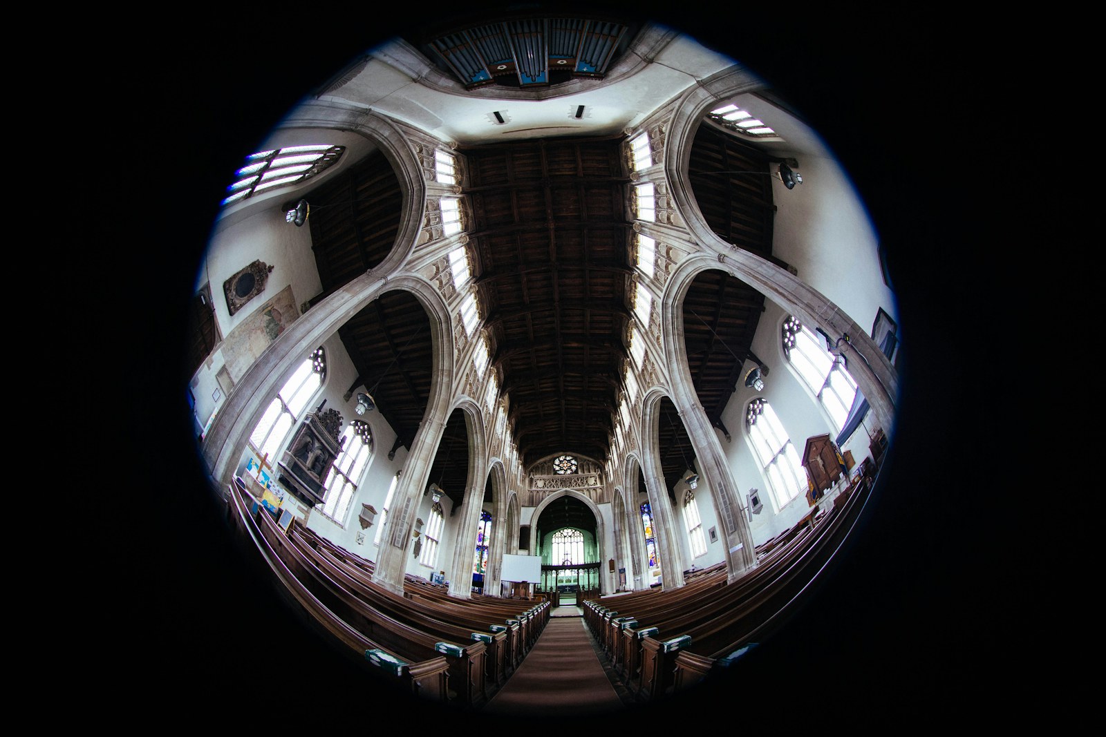 Interior of a grand church with pews and arched ceiling