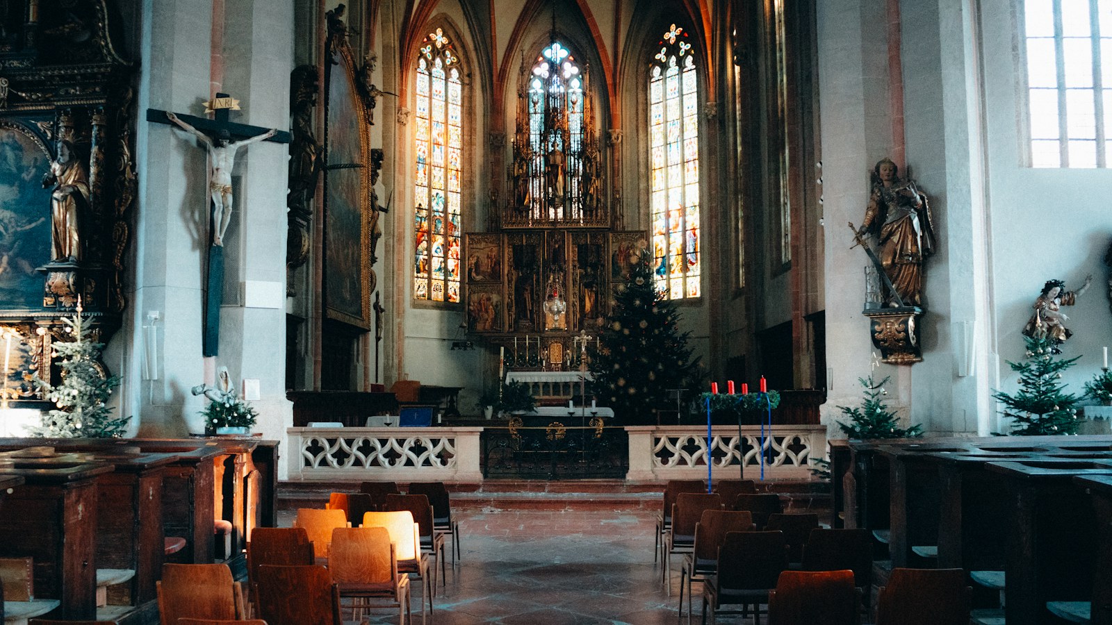 Interior of a church with stained glass windows and altar