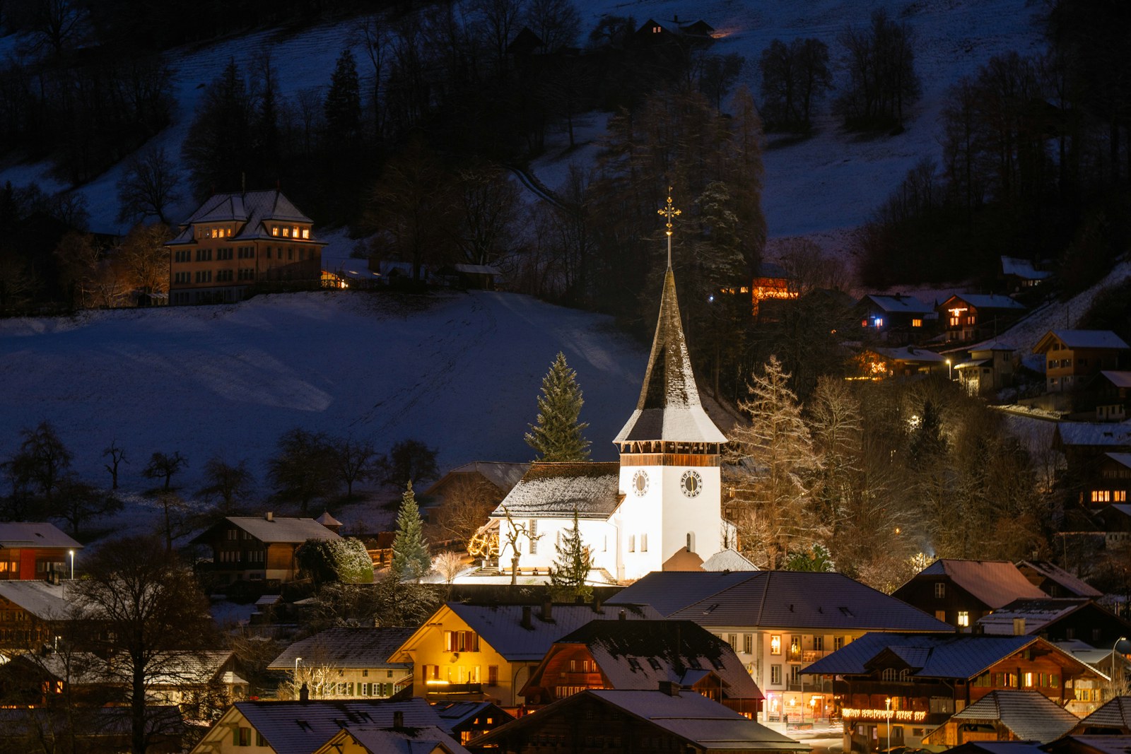 A town with a church lit up at night