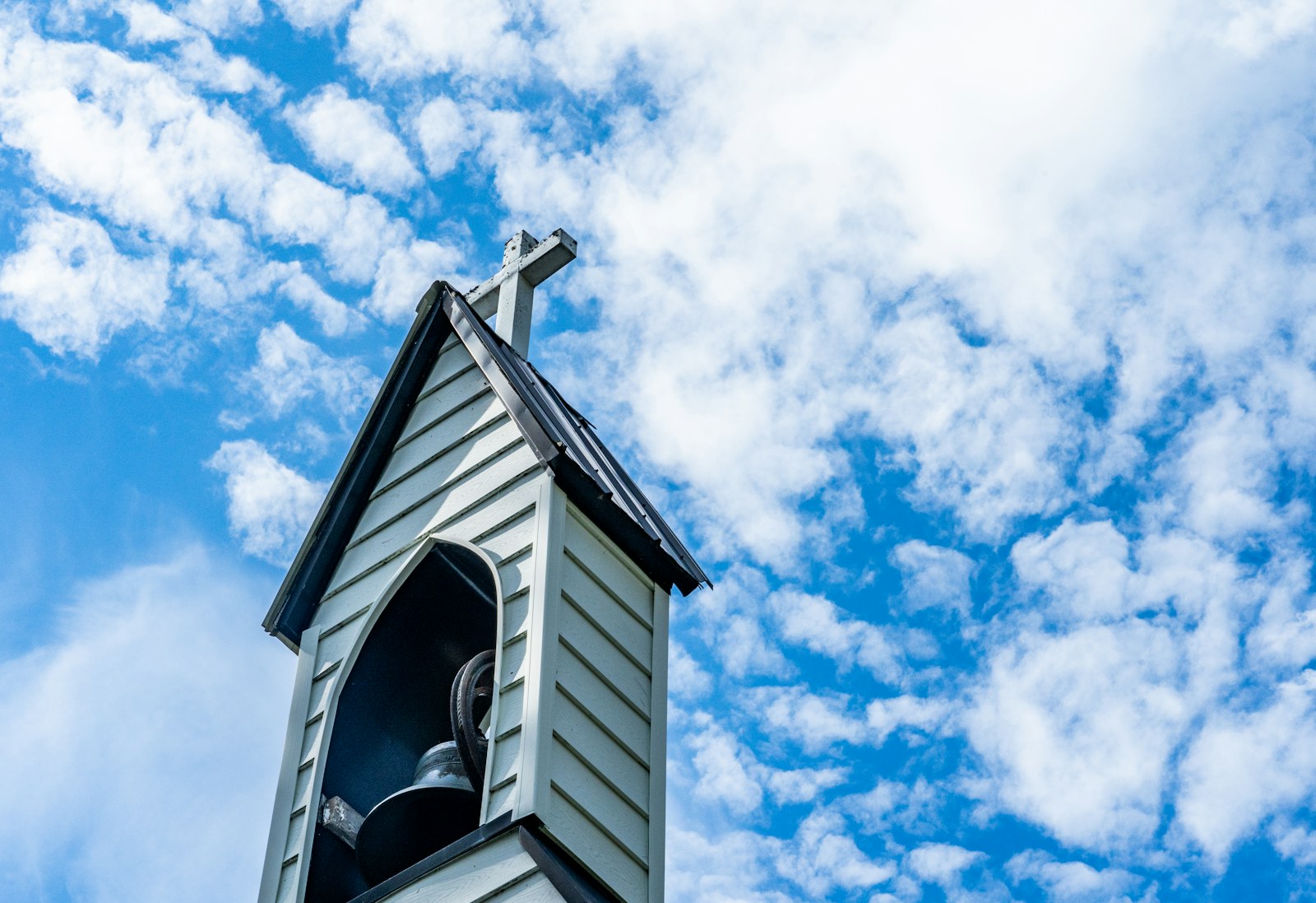 white and black wooden house under blue sky and white clouds during daytime