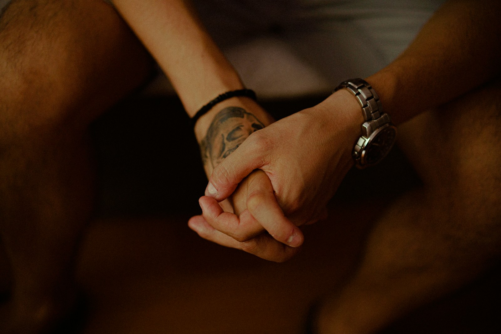 person wearing silver link bracelet watch