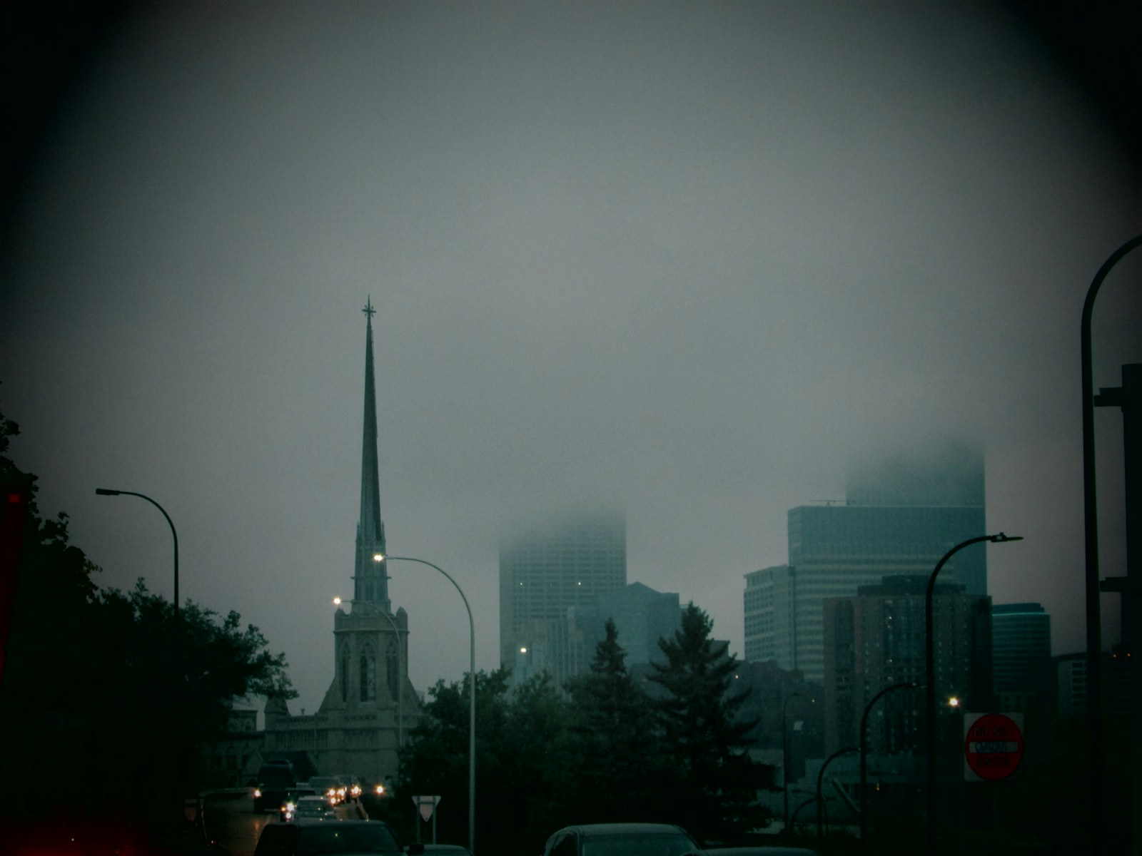 black car on road near high rise buildings during daytime