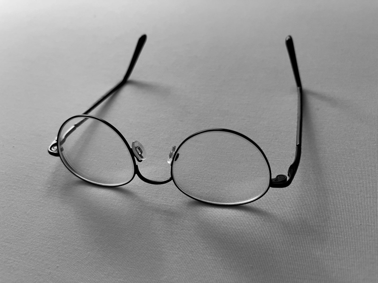 a pair of glasses sitting on top of a table