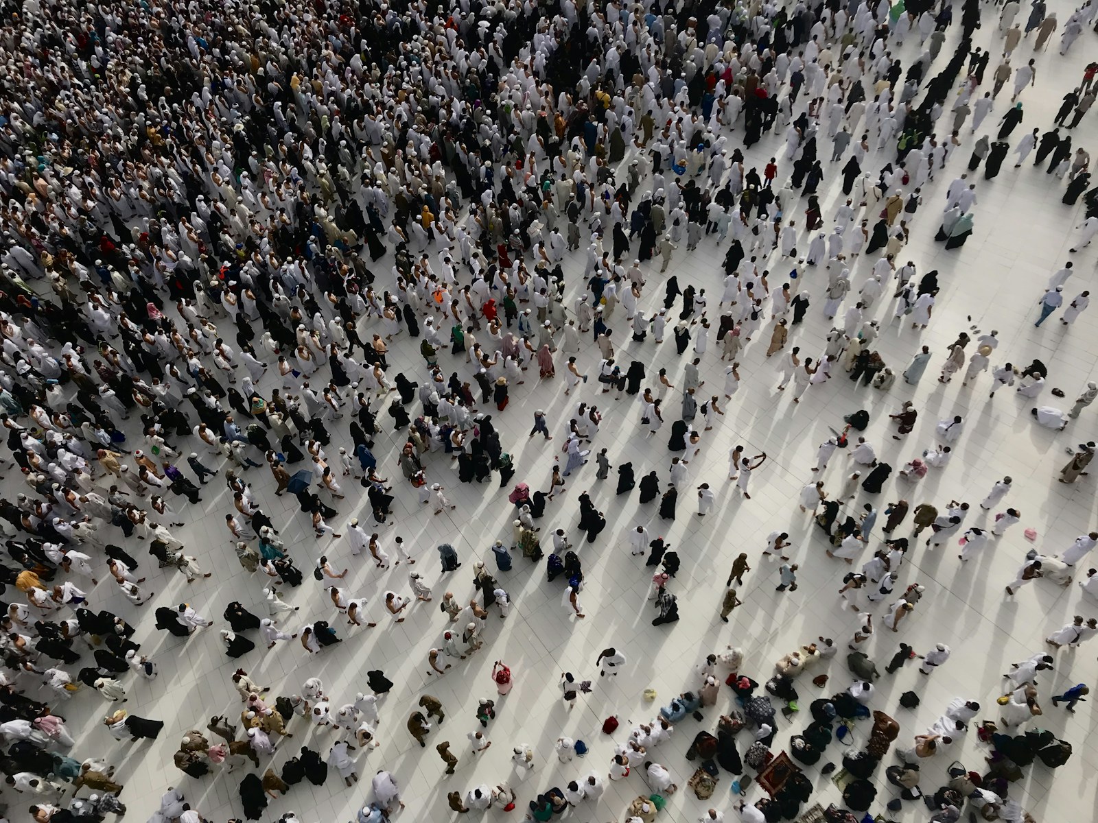 a large group of people standing in a large room