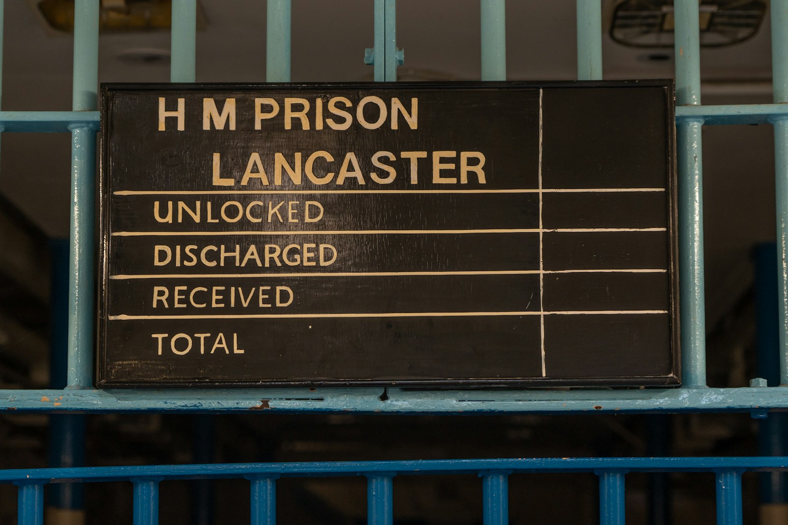 a sign on a blue railing