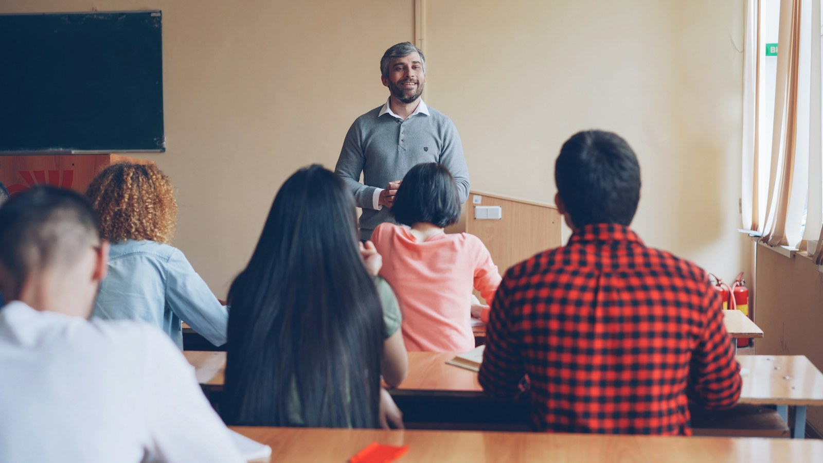 Teacher lecturing students in a classroom setting