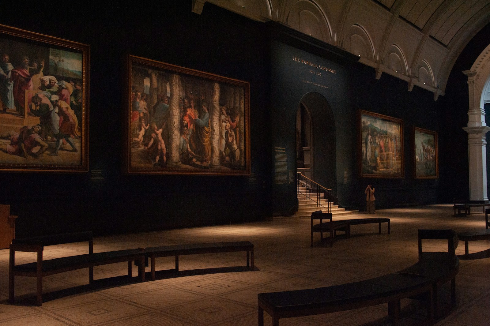 Inside of a grand museum exhibiting paintings