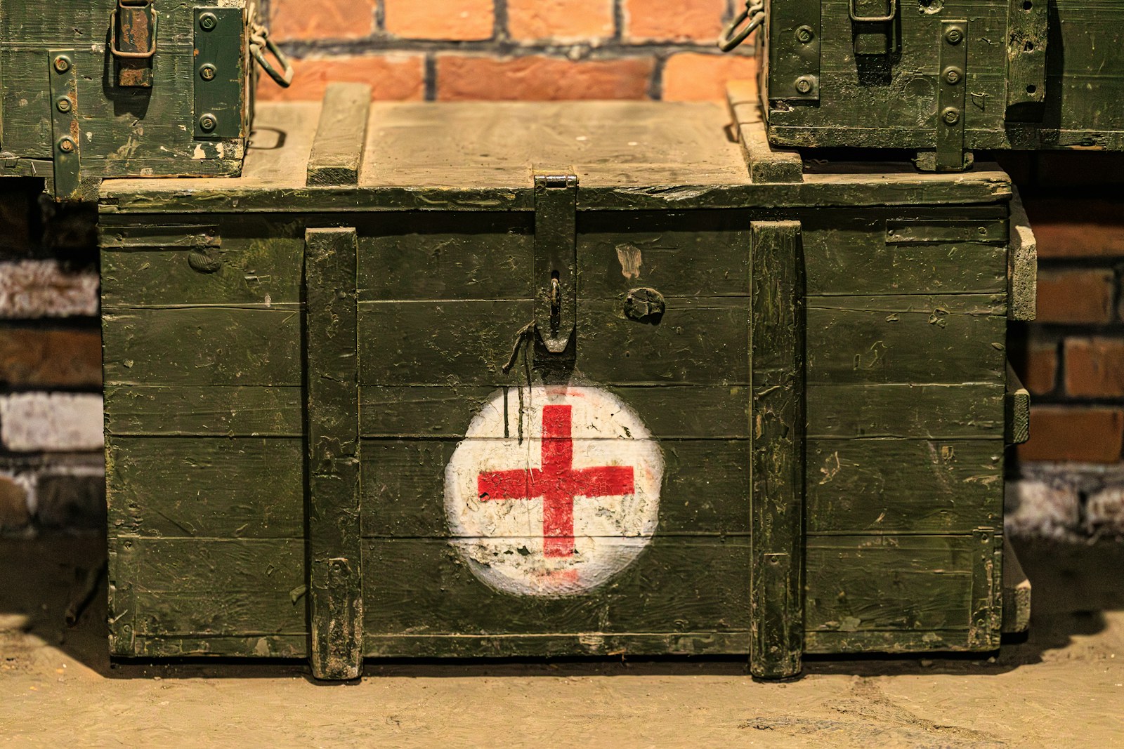 Green wooden chest with a red cross symbol