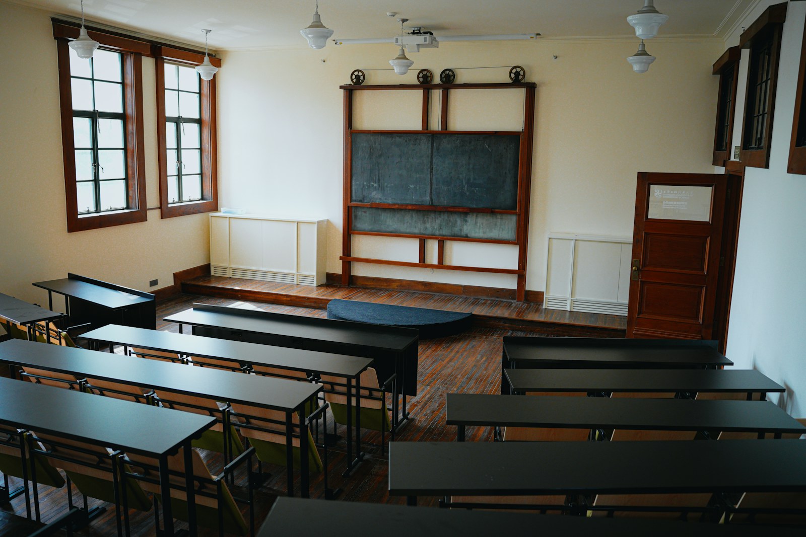 Empty classroom with wooden desks and blackboard
