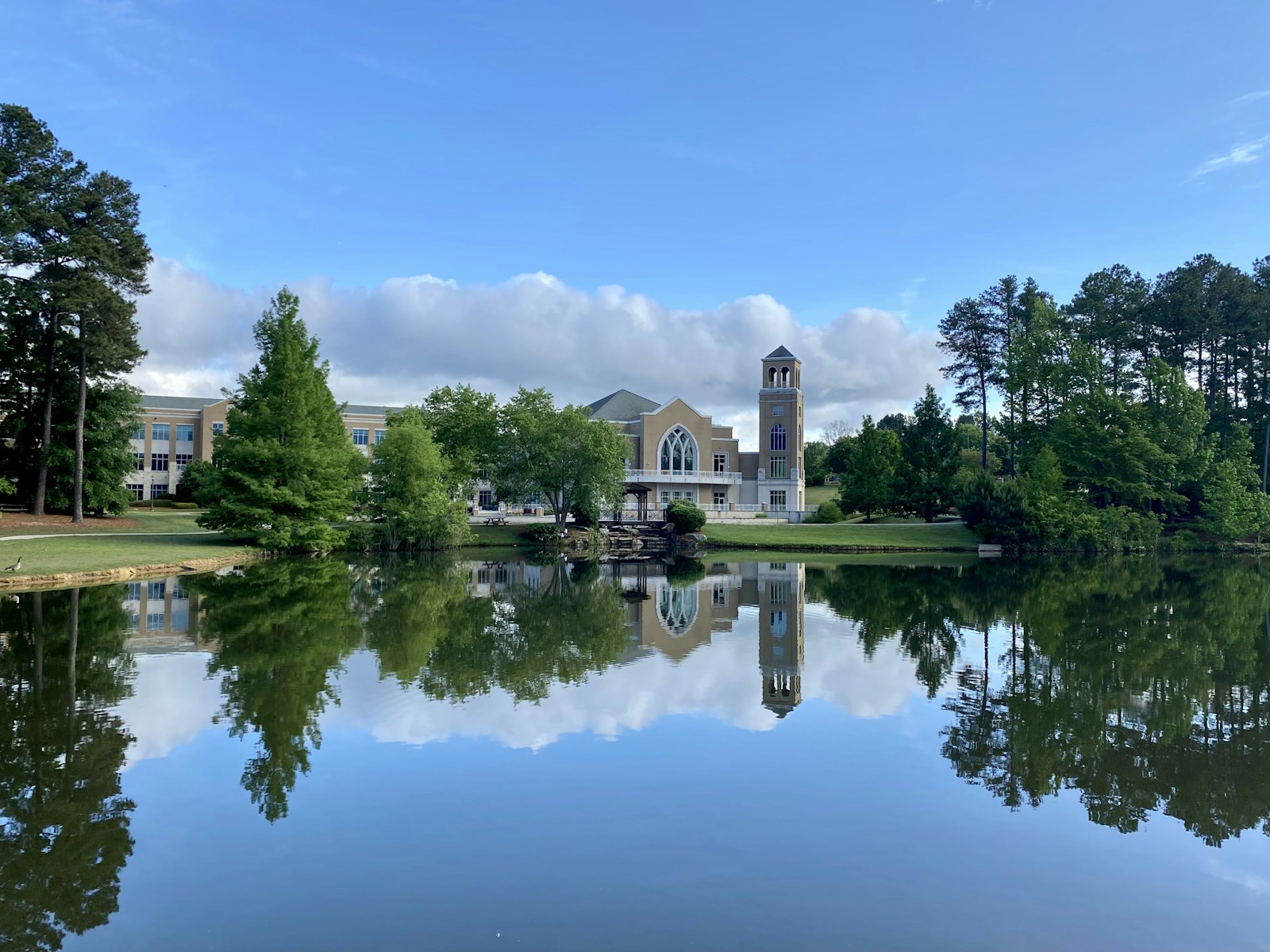 a lake with a clock tower in the background