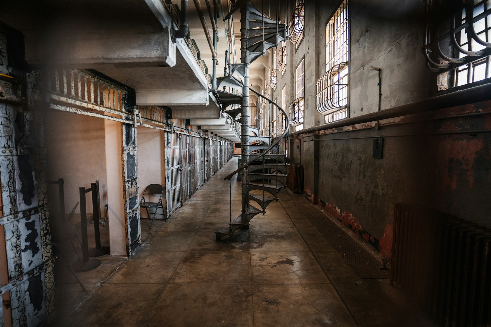 Abandoned prison cell block with spiral staircase