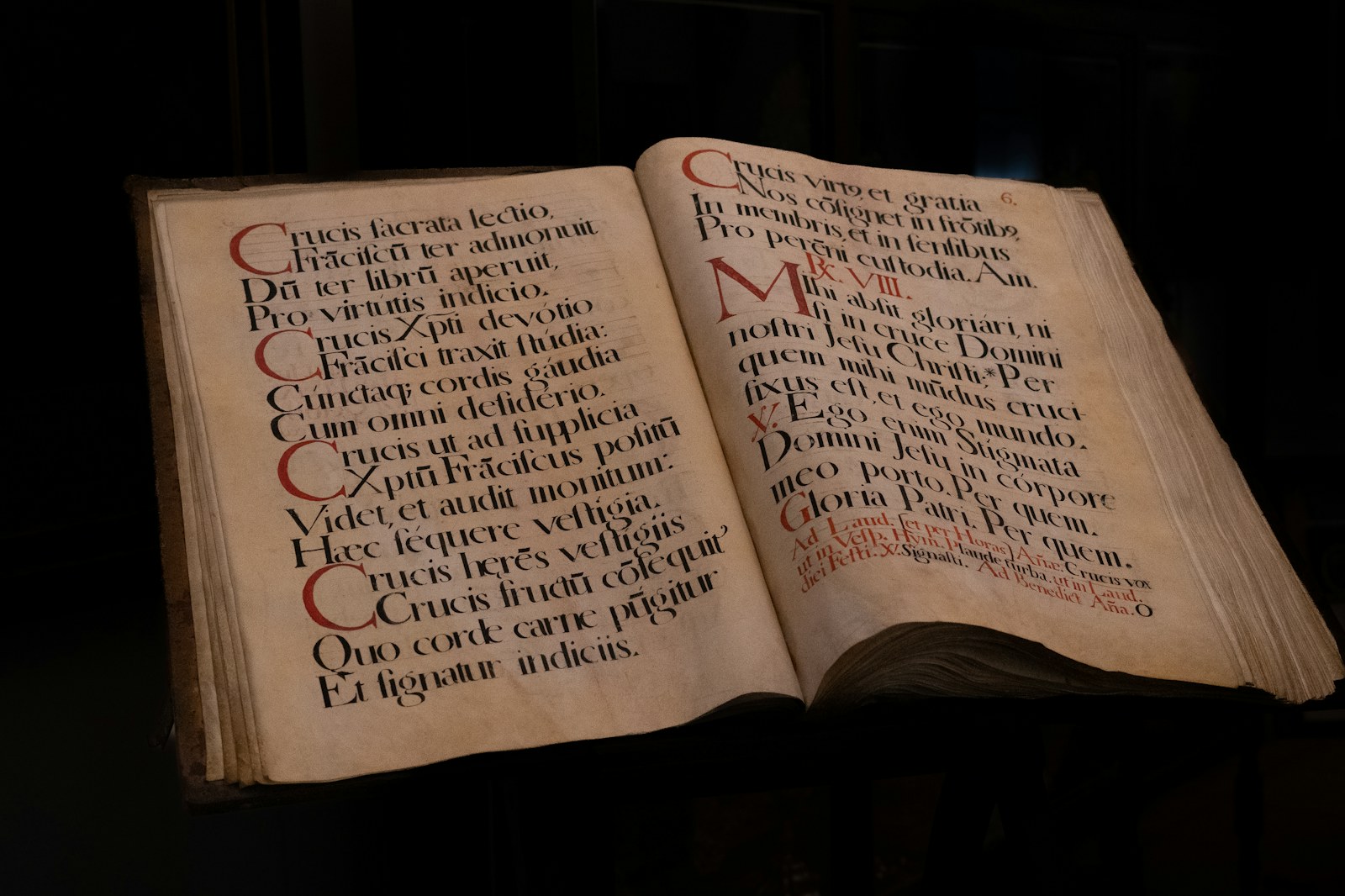 an open book with writing on it in a dark room