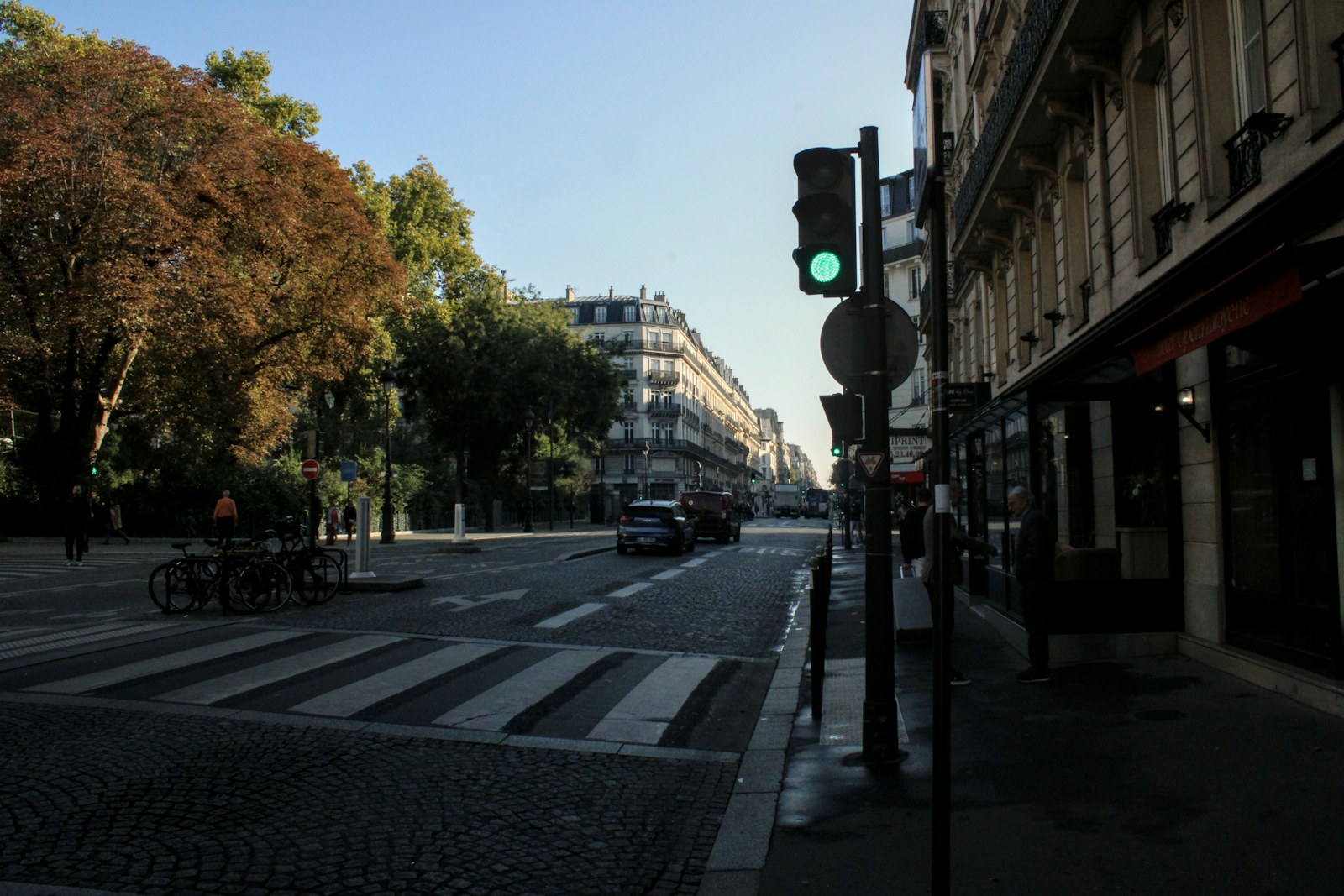 A street with a green traffic light and crosswalk
