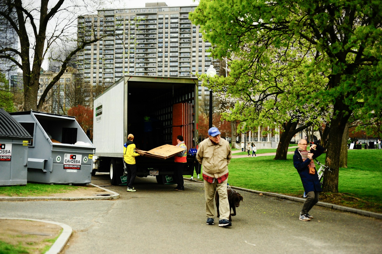 People unloading furniture from a moving truck outdoors