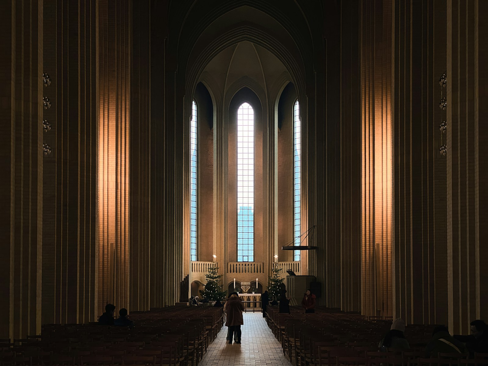 a person standing in front of a large window in a church