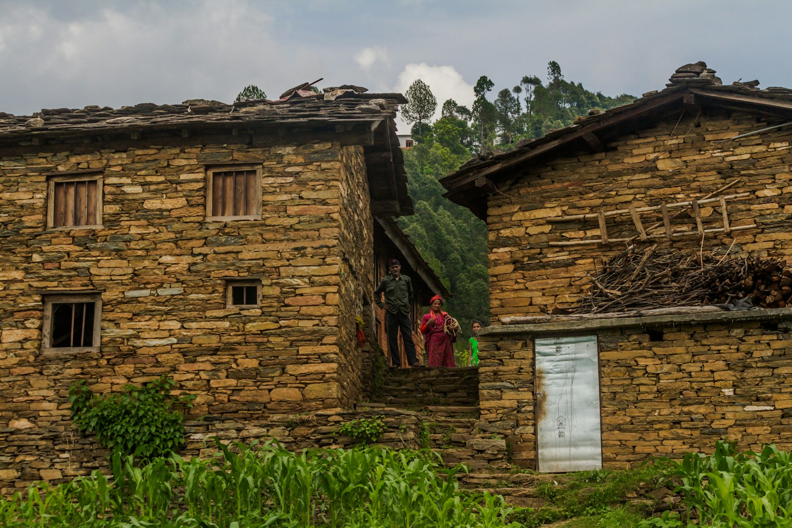 Stone houses with a woman in traditional clothing
